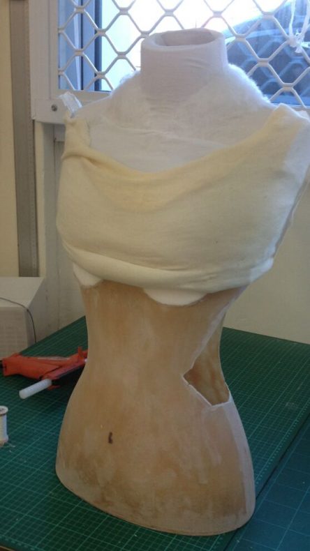 The mannequin torso with the bust and waist cut away. A cotton cover is attached to the newly shaped form ready for padding to be stitched into place. Photo by Sam Gatey, copyright Te Papa.