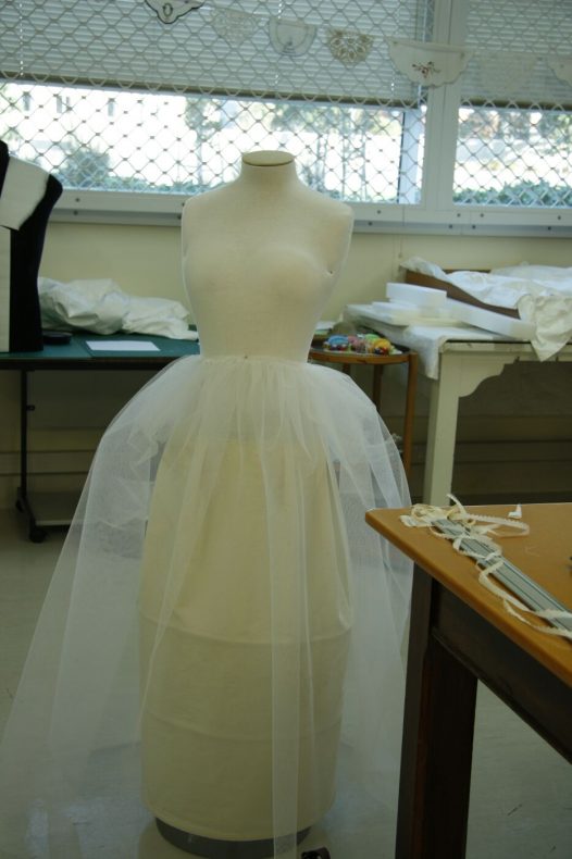 The torso after it has been padded into the correct size and period shape. There is a cotton tube underskirt to hold out the multiple layers of net underskirts instead of legs! Photo by S. Gatley, copyright Te Papa.