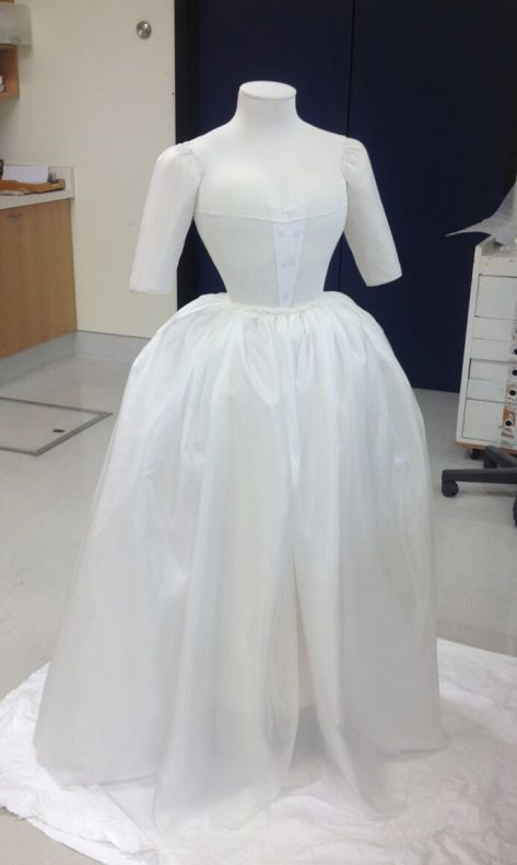 The near-finished mount, complete with silk petticoat, jersey top cover and sleeve supports. There are strong small magnets attached to the front which will hold the bodice section in position- These are needed as the dress doesn’t have any buttons or other fastening. The opposing magnets will be placed on the outside of the garment. These should be difficult to see as they will be coloured to match the dress. Photo by S. Gatley, copyright Te Papa.