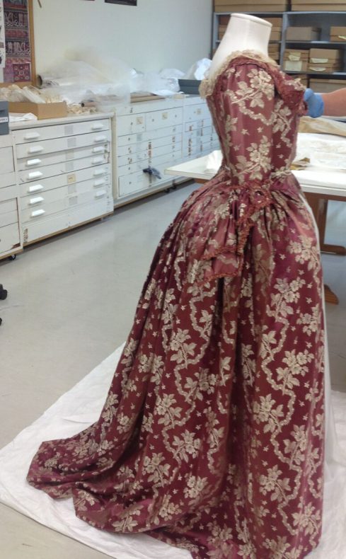 Here we are carrying out the final fitting of both the dress to unsure that the garment is properly supported but not under any stress. At this point we can also adjust the final height of the ensemble and check the silhouette that has been created. Photo by S. Gatley, copyright Te Papa.